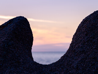 Dark silhouette of a rock formation during sunset