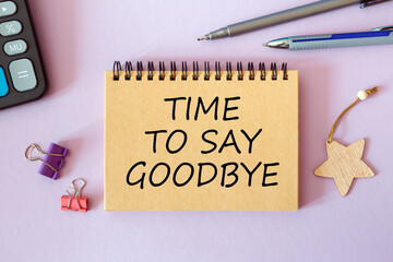 TIME TO SAY GOODBYE is written on a notepad on an office desk