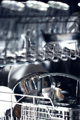 dishes in an open dishwasher, home style lifestyle, cleanliness and convenience background