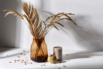 home improvement and decoration concept - still life of decorative dried flowers in brown glass...
