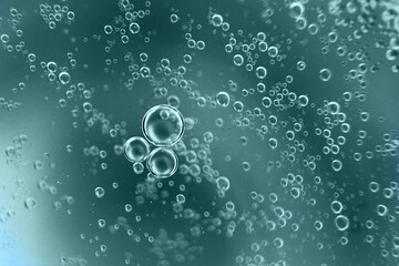 abstract tidewater green background with oil circles . water drops close up . oil bubbles in the water macro.