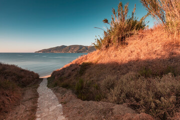 Cobbled walkway perspective, stone stairs to the sea