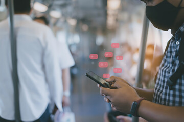 Man wearing mask using cell phone or smartphone with icons on train station or subway background ,Businessman using phone ,Social, media, Marketing concept .