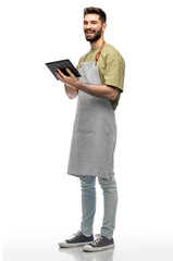 Naklejka na ściany i meble people, profession and job concept - happy smiling waiter or seller in apron with tablet pc computer over white background