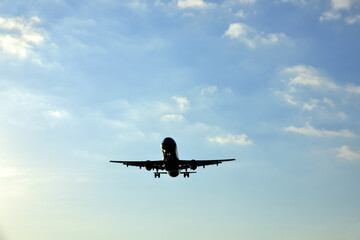 Silhouette of airplane with clear blue sky background