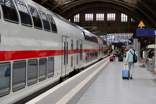 Two colored trains on railway station in germany
