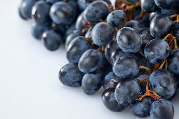 Grapes-clusters of ripe red grapes lie on a white background.Space for text