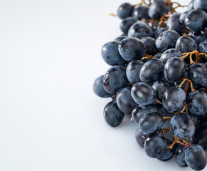 Grapes-clusters of ripe red grapes lie on a white background.Space for text
