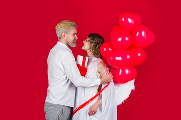 Couple of cupids. Valentine day. Love. Valentines day couple. Angel woman with balloons. Cupid in valentine day. Valentines Day. Heart shape balloons.
