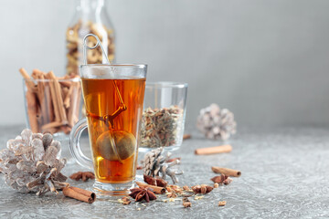 Herbal tea with spices on a grey background.