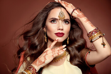 Portrait of beautiful indian girl in sari. Young hindu woman model with kundan golden jewelry set....