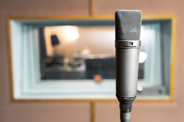 Professional condenser vintage classic vocal microphone in recording room studio. Against the...
