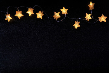 Christmas decoration with bright stars over black background