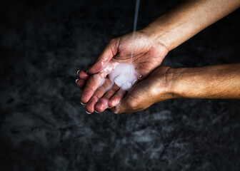 Obraz na płótnie Canvas Soap pouring on woman's hands