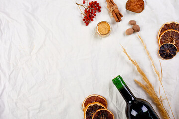 Flat lay of ingredients and bottle of red wine for winter seasonal mulled wine