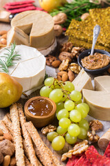 Plate of organic raw vegan cheese, snacks, nuts, fruits