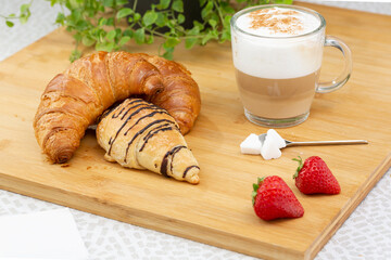 Croissant and coffee breakfast set in a studio shot.