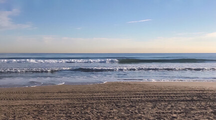 panoramic of a sunrise on the beach at the seashore with a beautiful clear sky