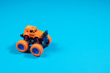 Children's toy jeep monster truck on blue background with place copy space for text - boy's car, toy store © Zarina Lukash