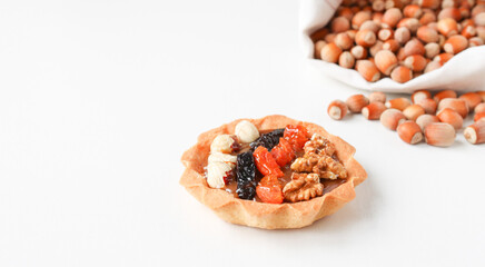 Dessert with dried fruit, in the background a bag of nuts.