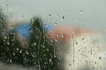 Concept of rainy and sad weather, depression and apathy. Raindrops on glass