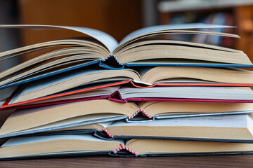 Books open, put on top of each other.