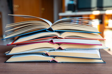 Books open, put on top of each other.