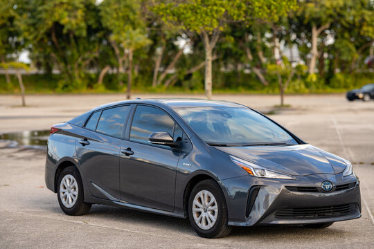 Miami, FL, USA - December 2, 2020: Toyota Prius hybrid electric gas car front passenger view