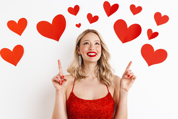 Blonde woman in red dress pointing