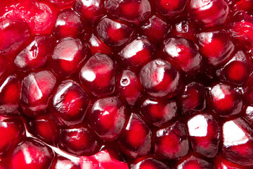 fresh pomegranate seeds macro close-up in drops