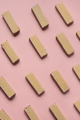 Waffle pattern on a pink background, waffles are in a row