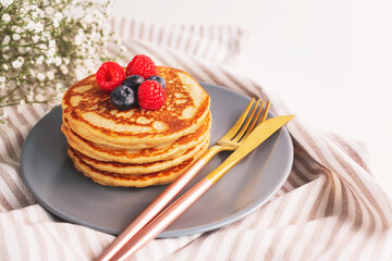 Homemade tasty pancakes for breakfast. Decorated with berries. Healthy eating concept.