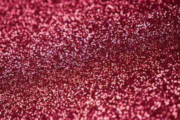 Pink glitter, blurred effect. Glowing holiday light circles are created from bokeh in the camera and lens. Background for design.