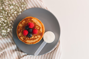 Collagen powder recipes concept. Pancakes made with collagen or protein  powder. Perfect tasty and healthy breakfast. Beauty supplements for skin and bones.