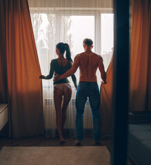 couple in the bedroom. Couple love. Sunset. Man and woman. 