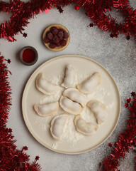 Prepared semi-finished products. Dumplings, khinkali, manti. New year's atmosphere