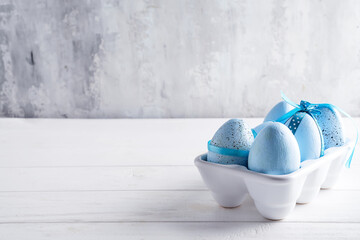 Organic blue easter eggs in porcelain decorative box on white. Holiday concept concept.