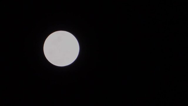 White moon in black night background