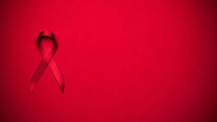 Hiv support. Red ribbon symbol in hiv world day on dark red background. Awareness aids and cancer....