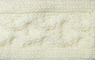 braided pattern fabric wool background. relax autumn and winter season arrangement flat lay style. Details of knitwear. knitted fabric texture. Texture of knit, large knitting. Top view, macro