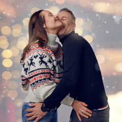 Middle-aged happy couple laughing in winter time with snow around