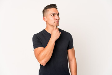 Fototapeta premium Young caucasian handsome man isolated looking sideways with doubtful and skeptical expression.