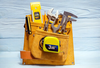 Set of tools in suede bag for master builders on blue boards