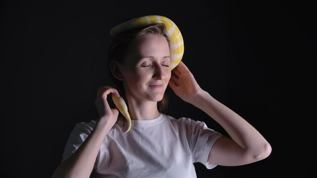 Slow motion of woman with python albino crawling on her head