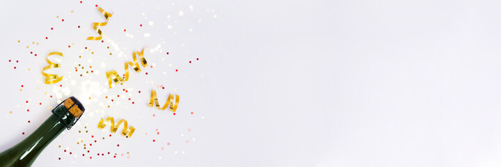 Banner with champagne bottle with confetti and party streamers on white background. Christmas,...