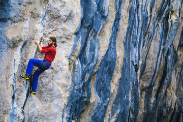 A strong man climbs a rock, Rock climbing in Turkey.