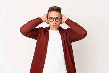 Young caucasian handsome man isolated screaming, very excited, passionate, satisfied with something.