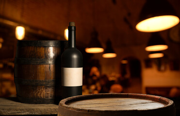 Glass bottle of wine with corks on wooden table background