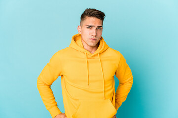 Young caucasian handsome man isolated frowning face in displeasure, keeps arms folded.