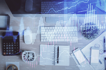 Multi exposure of forex graph drawing over desktop background with computer. Concept of financial analysis. Top view.